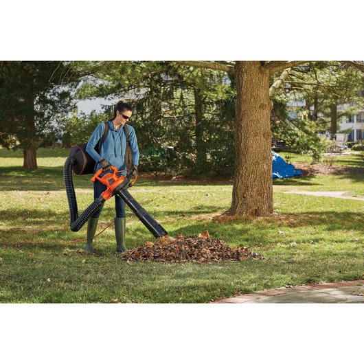 3 in 1 VAC PACK being used by person to collect dry leaves from park.