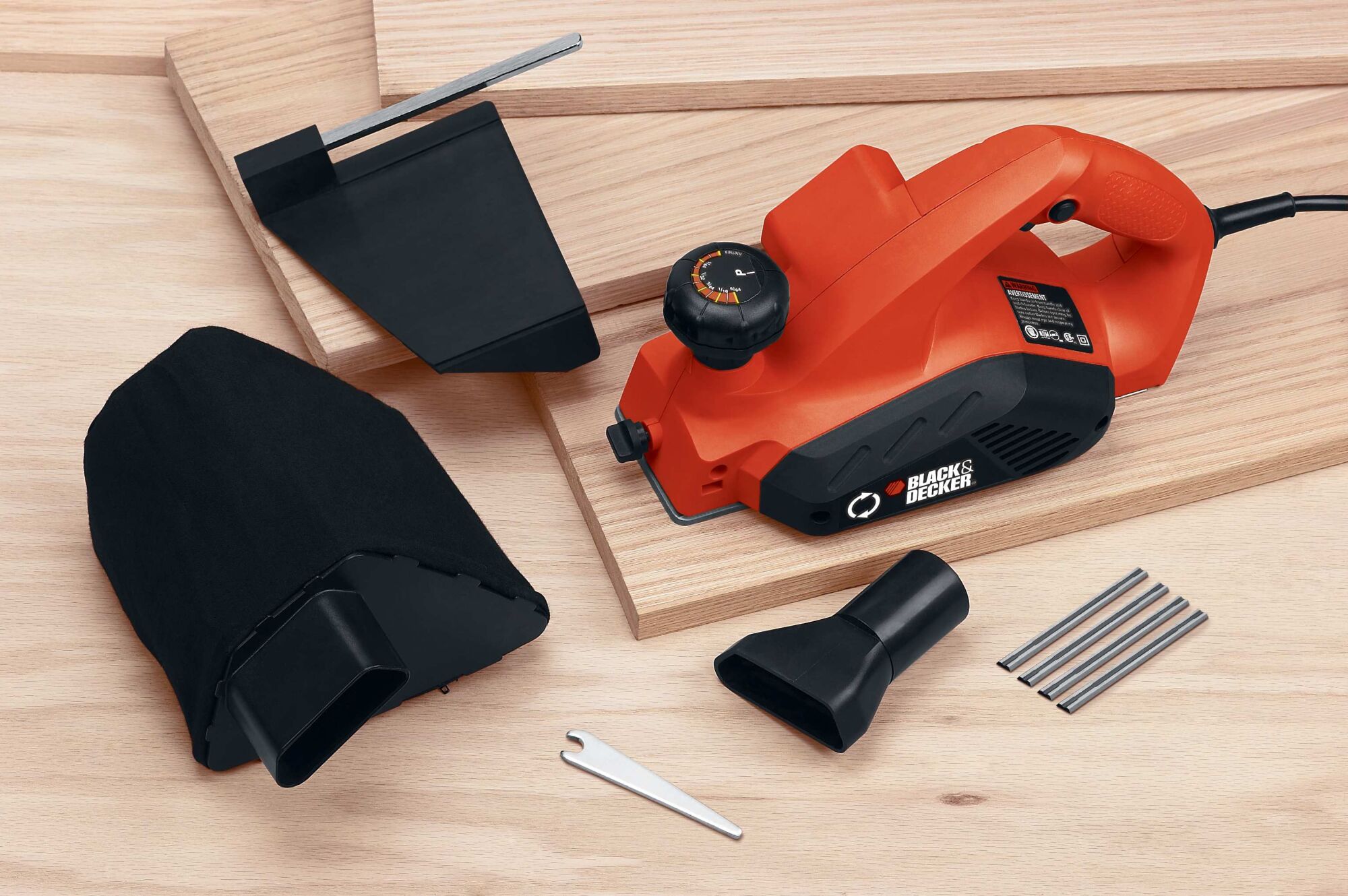 5 and 2 tenths Ampere 3 one quarter inch Planer with accessories placed on wooden planks.