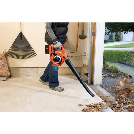 Lithium sweeper and vacuum being used to blow leaves.